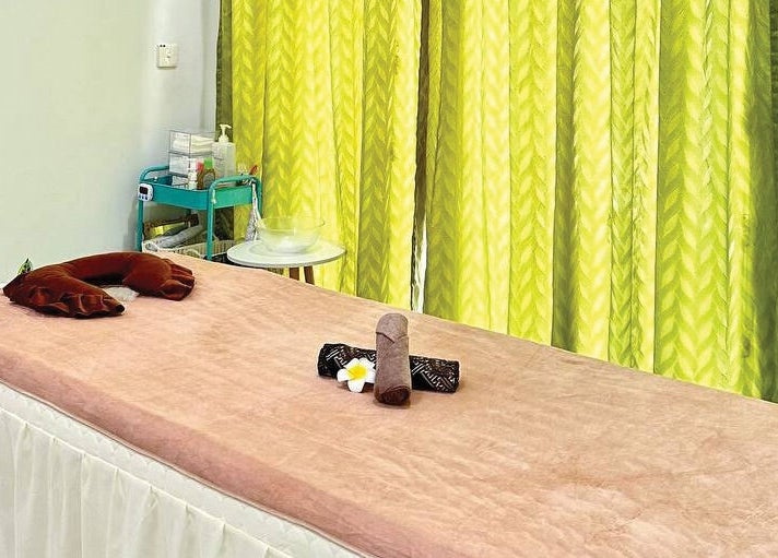 Tranquil massage bed at Belaian Emas Spa, Puncak Alam, Selangor, MY, perfect for relaxation.