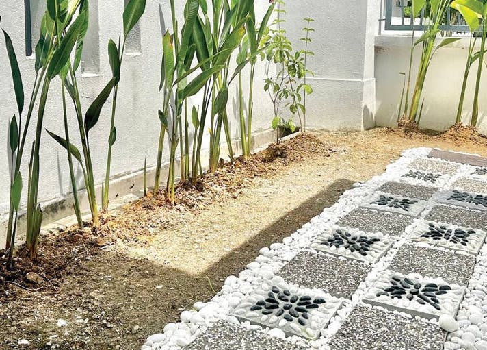 Elegant stone path and lush greenery at Belaian Emas Spa, Puncak Alam, Selangor, MY.