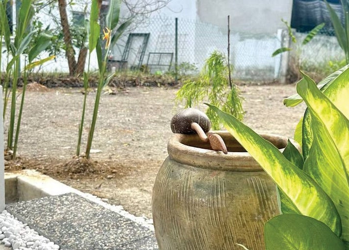 Lush garden view at Belaian Emas Spa, Puncak Alam, Selangor, MY, showcasing tropical plants and tranquil decor.
