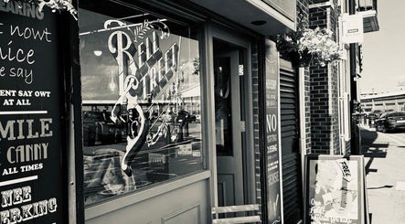 Entrance of Bell St. Barbers, North Shields, England, GB showing stylish signage and exterior.