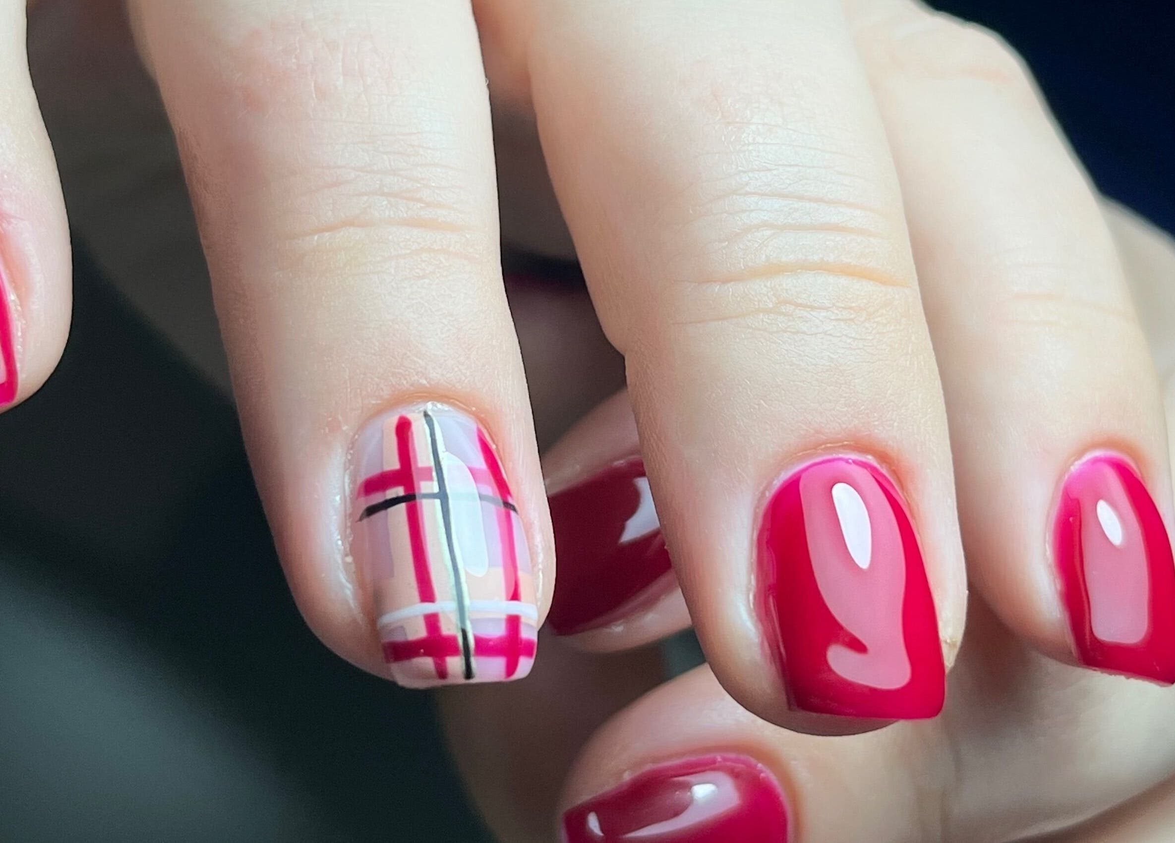 Stylish red and plaid nail design at Nailicious by Vanessa in Stockport, GB.