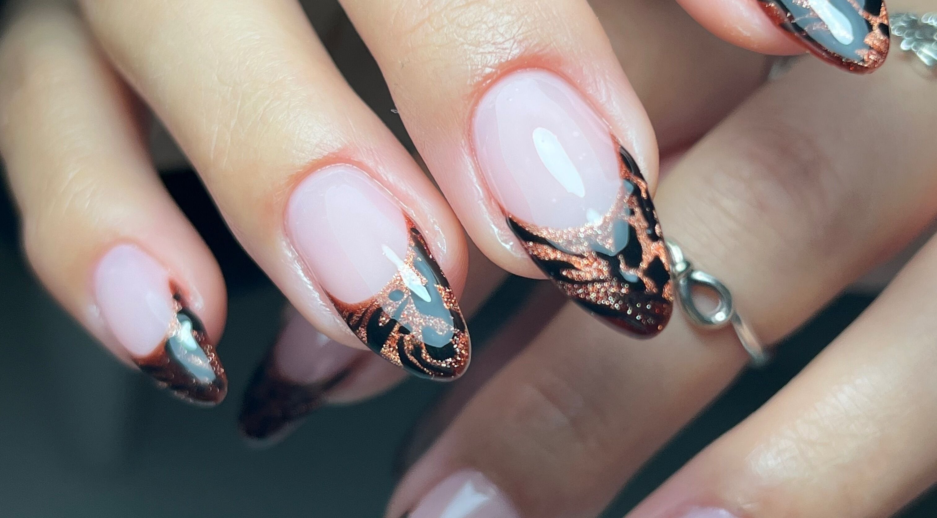Close-up of artistic nail design at Nailicious by Vanessa, Stockport, GB showcasing intricate rose gold patterns.