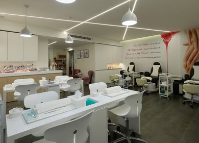 Modern, spacious interior of Annabelle Nail & Beauty Lounge in محافظة جبل لبنان, LB with sleek white stations.
