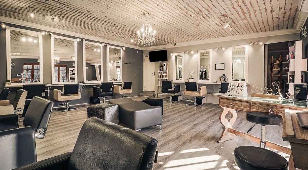 Elegant interior of Salon on Nutans in Cape Town, Western Cape, ZA with stylish chairs and mirrors.