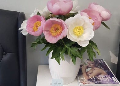 Chic floral arrangement at MiKa Salon, London, England, GB, enhancing a luxurious black seating area.