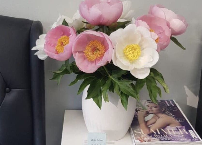 Chic floral arrangement at MiKa Salon, London, England, GB, enhancing a luxurious black seating area.