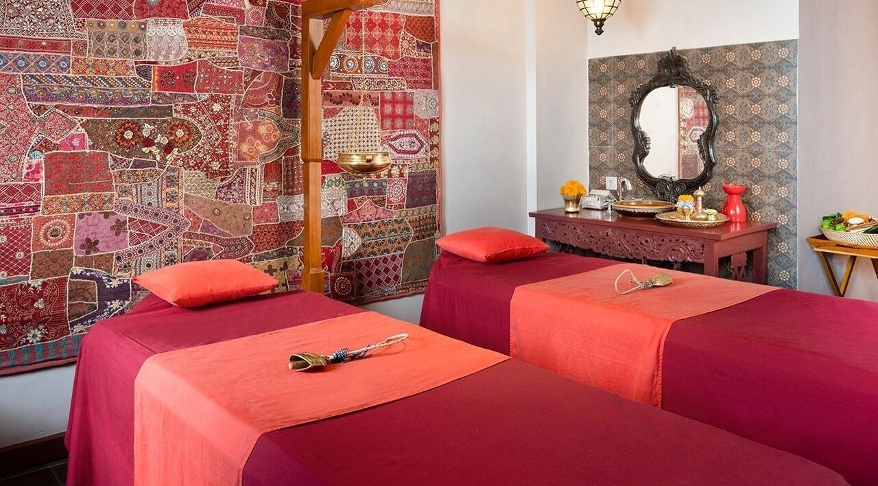 Luxurious massage room at Tejas Spa At Adiwana Resort Jembawan, Bali, Bali, ID with vibrant decor and elegant furnishings.