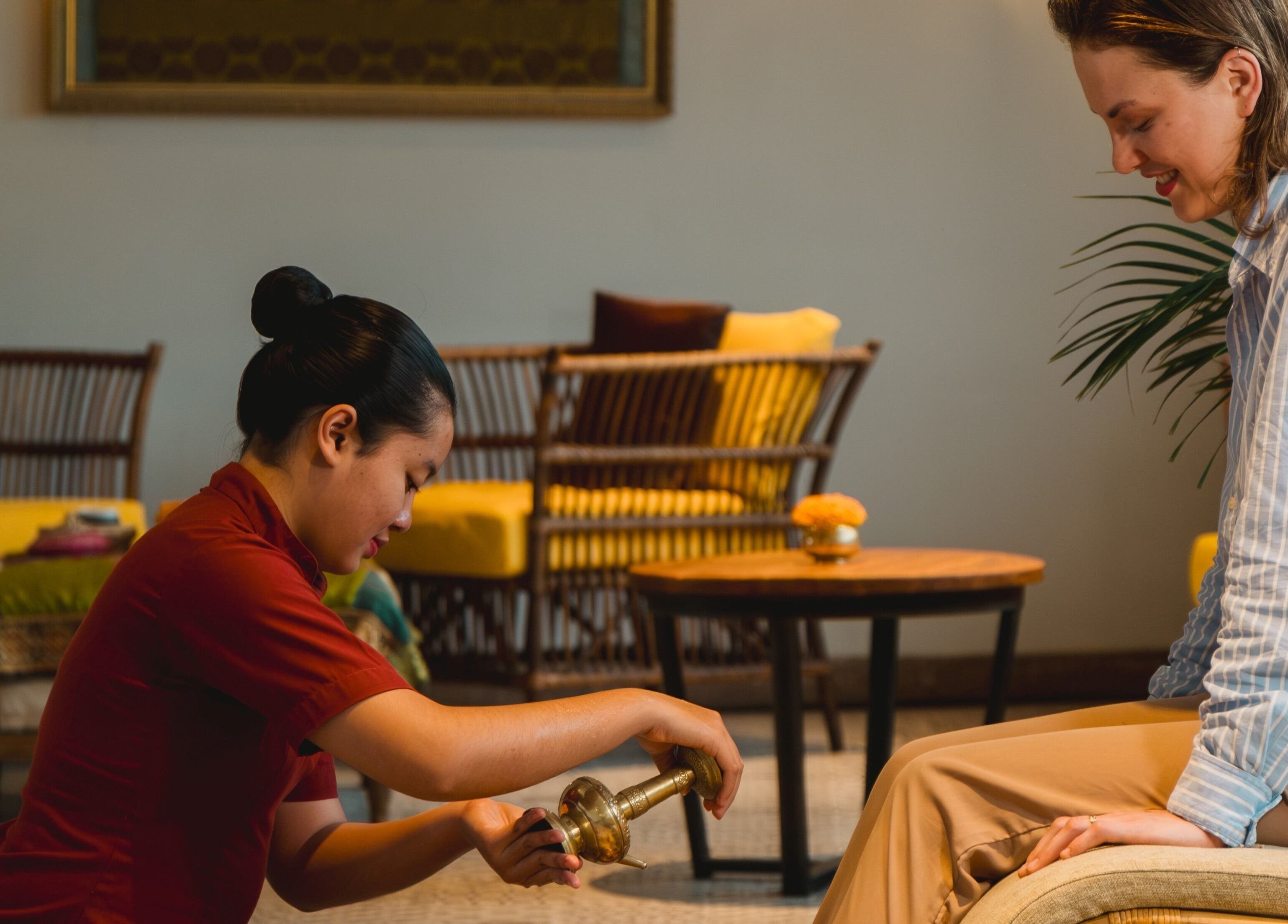 Therapist giving luxury massage at Tejas Spa At Adiwana Resort Jembawan, Bali, Bali, ID.