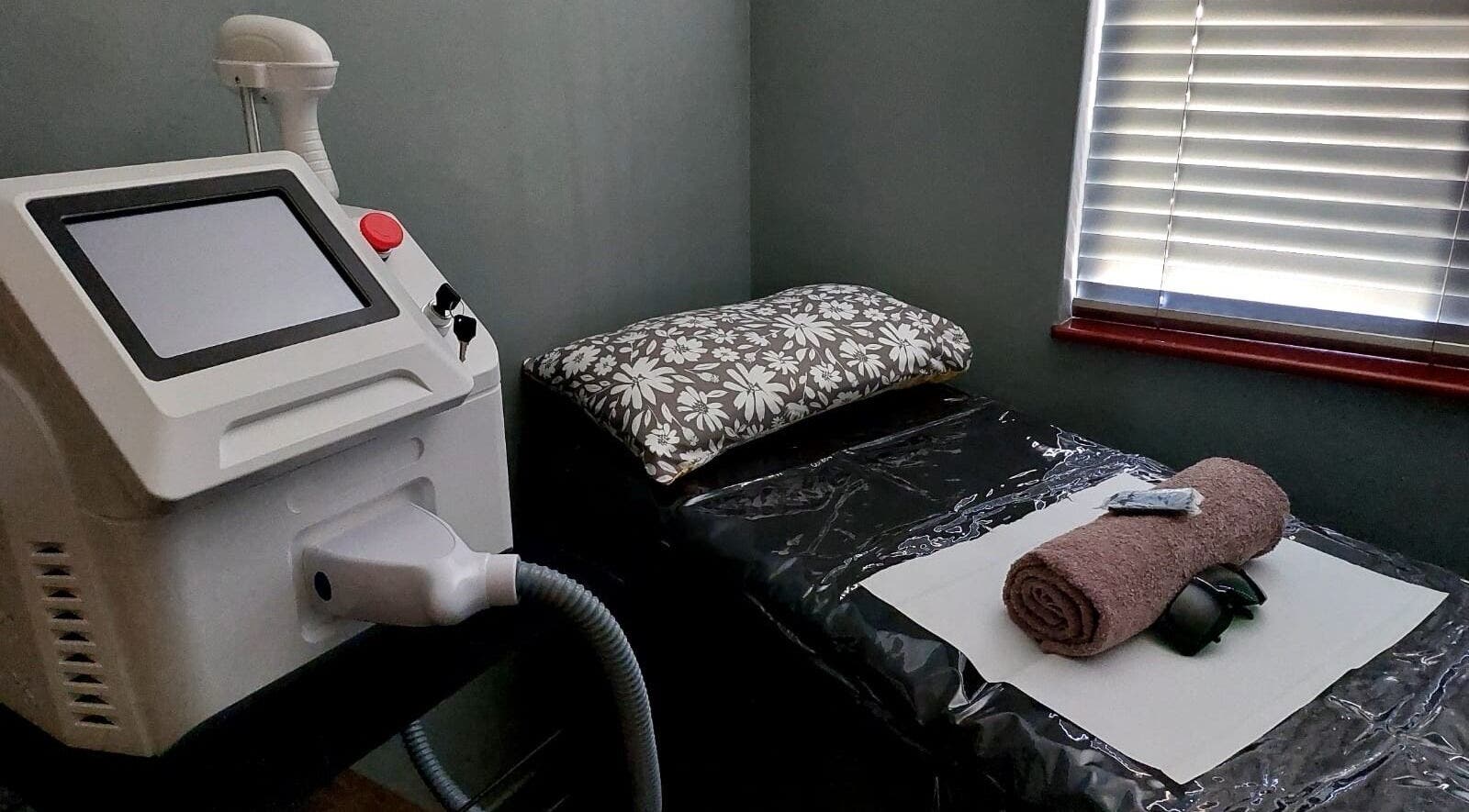 Modern laser treatment room at Elle Esthetics Brackenfell, Cape Town, Western Cape, ZA, with a rolled towel.