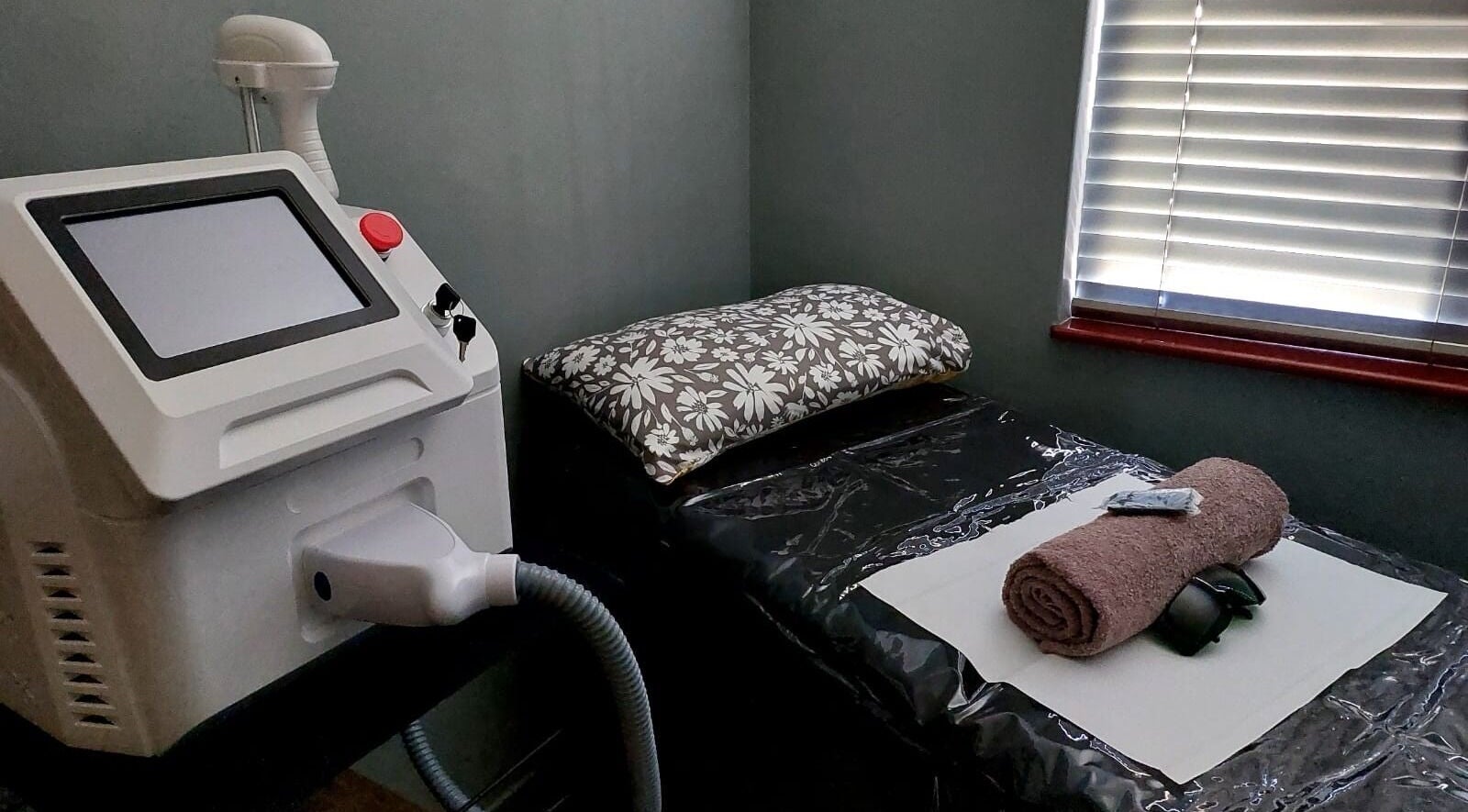 Modern laser treatment room at Elle Esthetics Brackenfell, Cape Town, Western Cape, ZA, with a rolled towel.