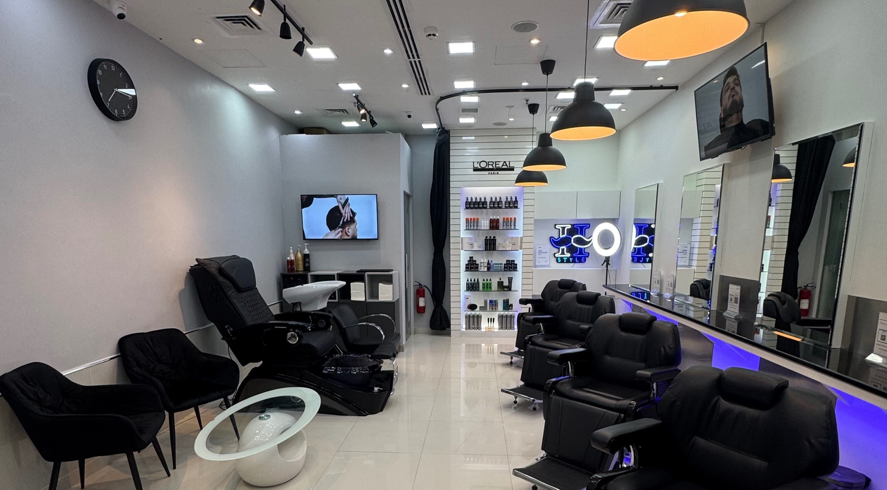 Interior of Style H Gents Salon in Dubai, Dubai, AE showcasing modern barber chairs and styling products.