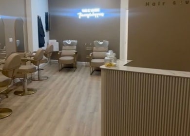 Interior of Ellie at Cloud & Co salon, Hinckley, England, GB, with elegant chairs and mirrors.