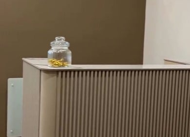 Elegant reception desk at Ellie at Cloud & Co, Hinckley, England, GB with a decorative glass jar.