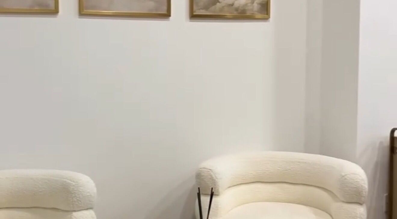 Elegant lounge area at Ellie at Cloud & Co, Hinckley, England, GB featuring plush seating and serene wall art.