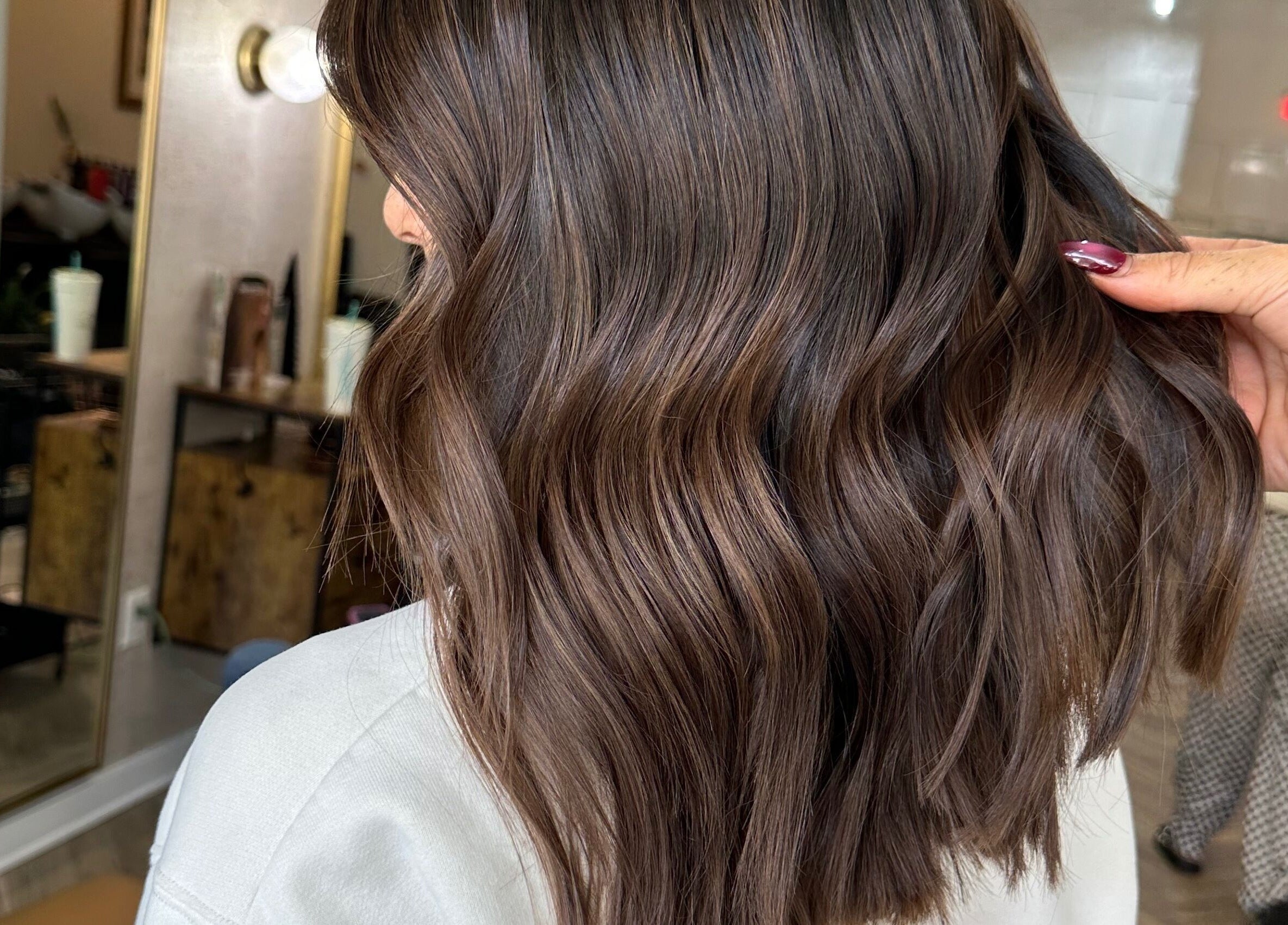 Stylish wavy brunette hairstyle at Color by Gia x Vion Boutique Salon, Boca Raton, Florida, US.