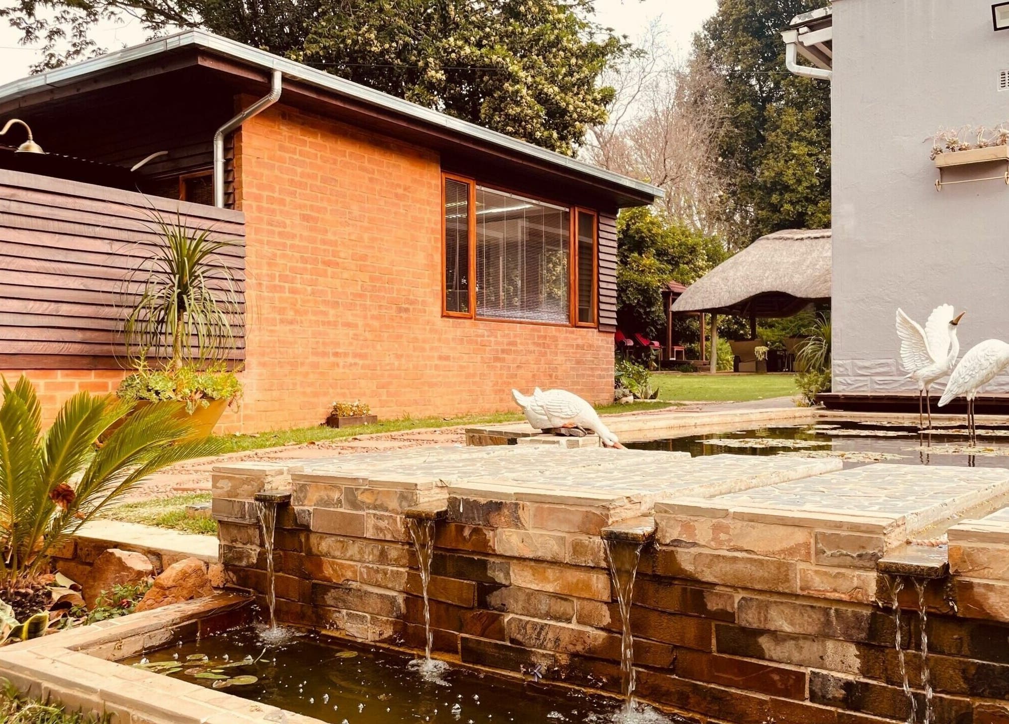Relaxing garden with water features and sculptures at Sweet Face Thai Health Centre, Pretoria, Gauteng, ZA.