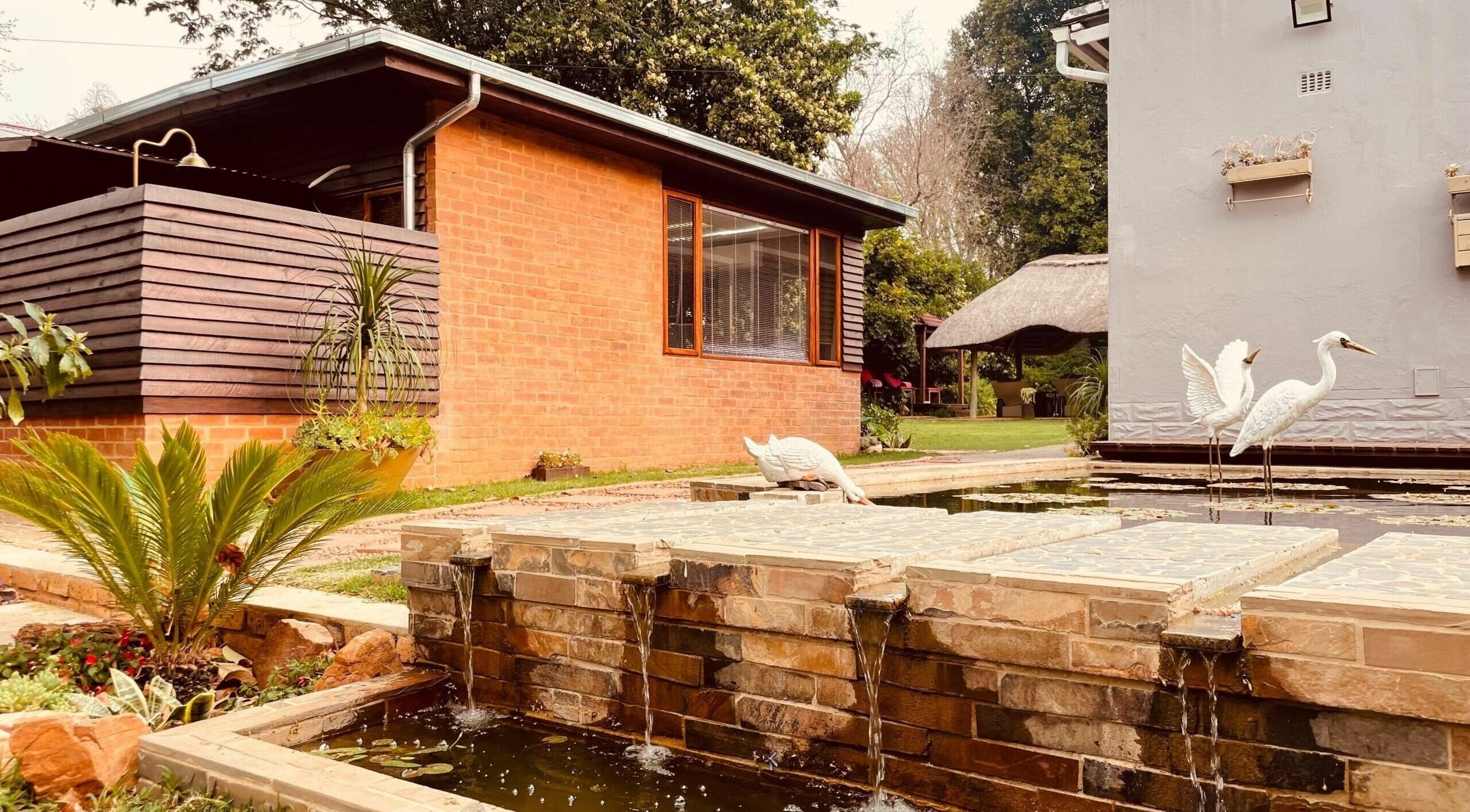 Relaxing garden with water features and sculptures at Sweet Face Thai Health Centre, Pretoria, Gauteng, ZA.