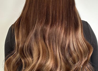 Beautiful wavy brown hair styled at Hair at Mollys, Cardiff, Wales, GB, showcasing shine and volume.