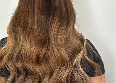 Golden brown wavy hair showcased at Hair at Mollys, Cardiff, Wales, GB, highlighting salon expertise.