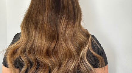 Golden brown wavy hair showcased at Hair at Mollys, Cardiff, Wales, GB, highlighting salon expertise.