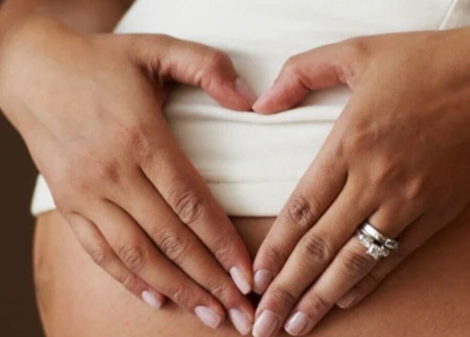 Hands forming a heart on a belly at The Little Gem Spa Massage, North Perth, Western Australia, AU.