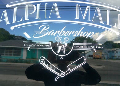 Front signage of The Alpha Male Barbershop in Nassau, New Providence, BS reflecting classic aesthetic.