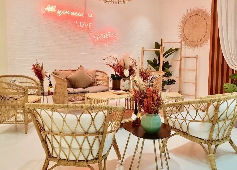 Relaxing seating area at Beauty Chic Salon Lounge, Sharjah, Sharjah, AE with cozy decor and neon sign.