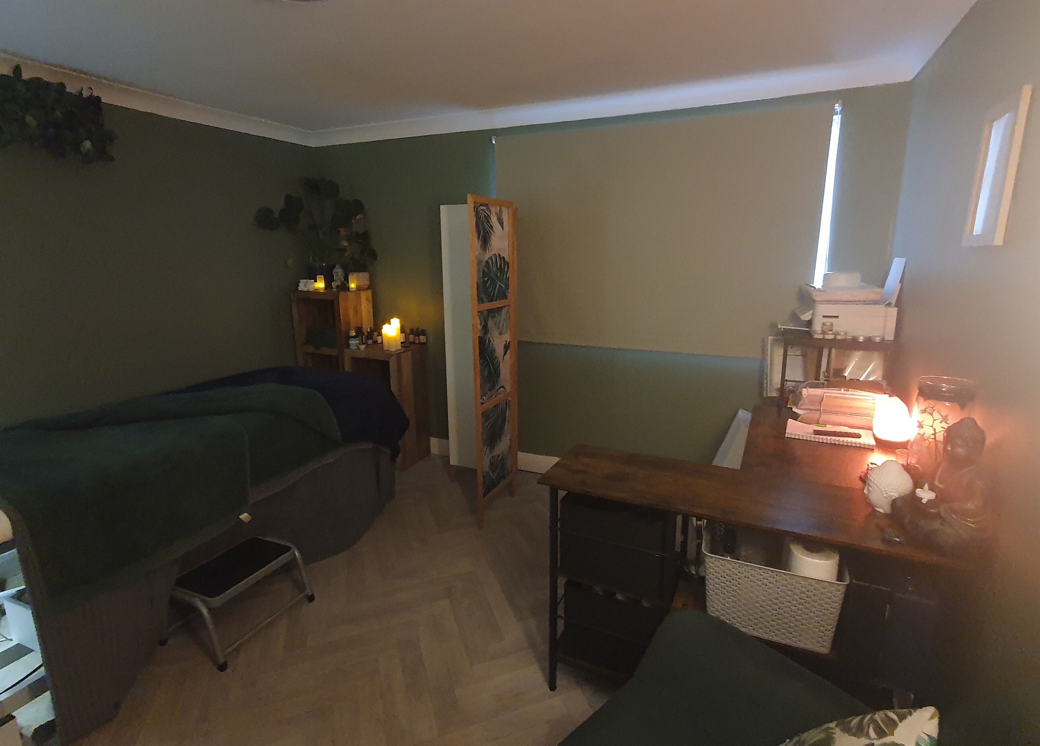 Cozy therapy room at Monoi Therapies, Marske-by-the-sea, England, GB, featuring massage table and ambient lighting.