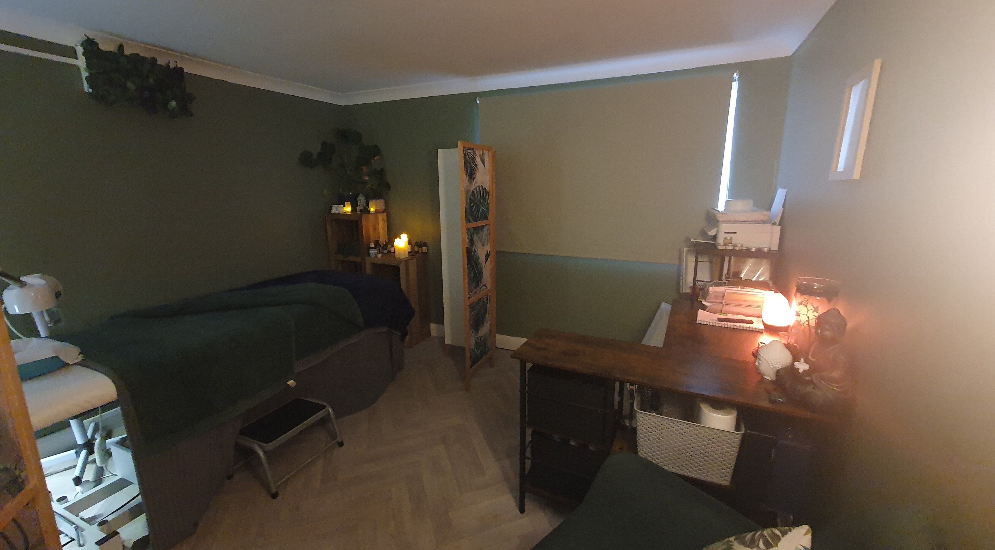 Cozy therapy room at Monoi Therapies, Marske-by-the-sea, England, GB, featuring massage table and ambient lighting.