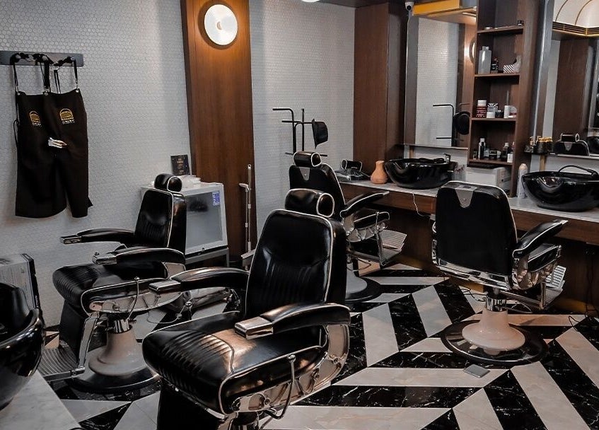 Interior of Crisp Barberia in Daerah Khusus Ibukota Jakarta featuring sleek black barber chairs and modern decor.