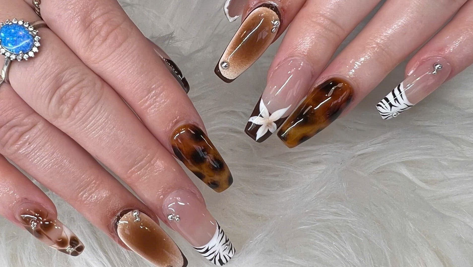 Elegant nail art featuring marble and floral designs at TH Nails and Spa Geelong West, Geelong West, Victoria, AU.
