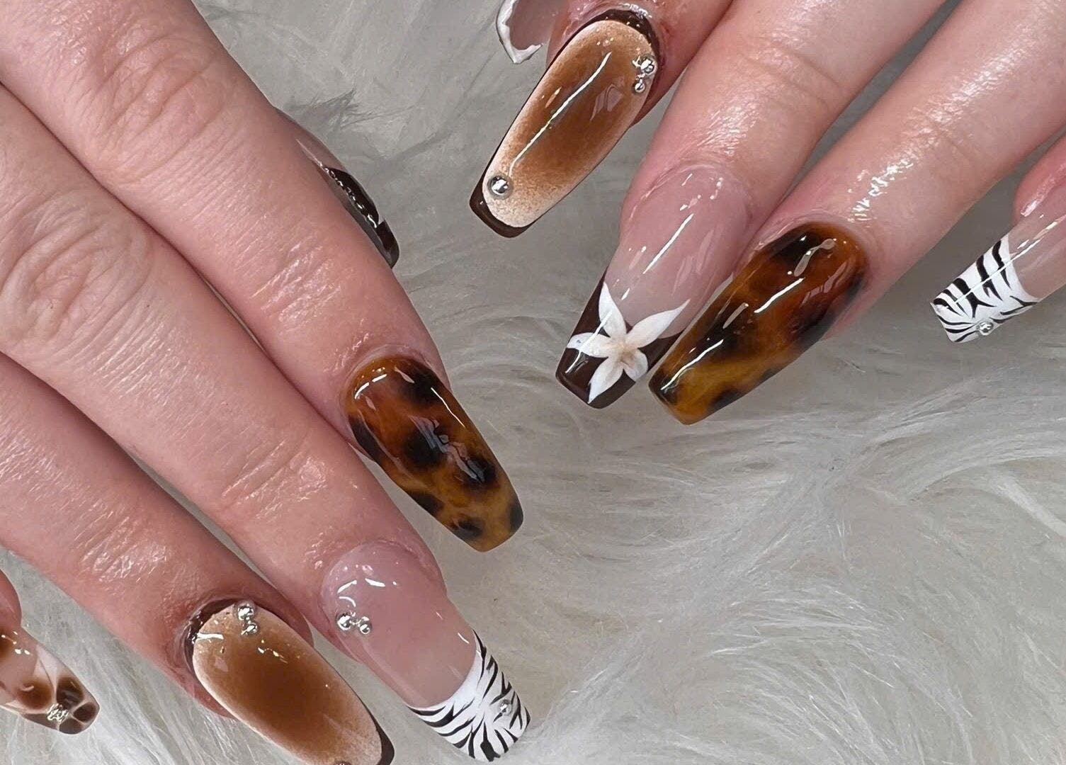 Elegant nail art featuring marble and floral designs at TH Nails and Spa Geelong West, Geelong West, Victoria, AU.