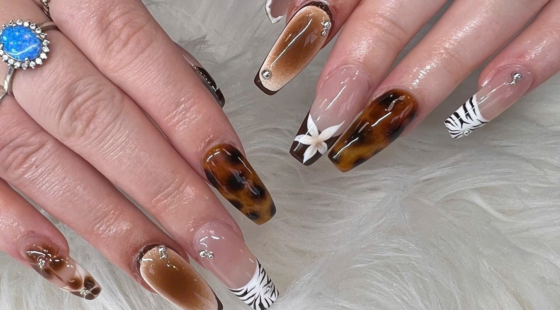 Elegant nail art featuring marble and floral designs at TH Nails and Spa Geelong West, Geelong West, Victoria, AU.