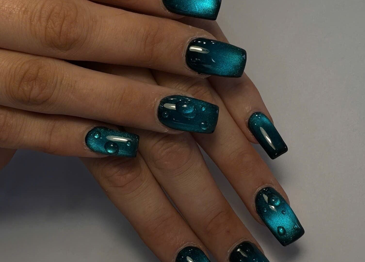Stylish teal manicure with water droplet design at TH Nails and Spa Geelong West, Geelong West, Victoria, AU.