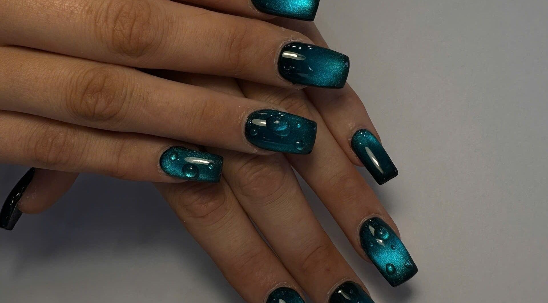 Stylish teal manicure with water droplet design at TH Nails and Spa Geelong West, Geelong West, Victoria, AU.