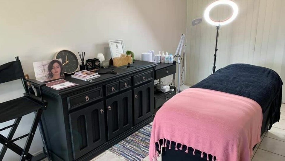 Cozy treatment room at Onyx Brows, North Mackay, Queensland, AU, featuring a pink and black styled bed.