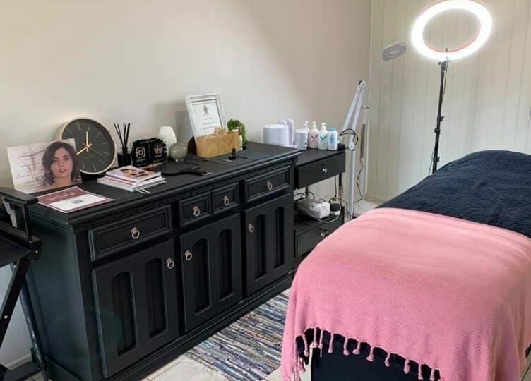 Cozy treatment room at Onyx Brows, North Mackay, Queensland, AU, featuring a pink and black styled bed.