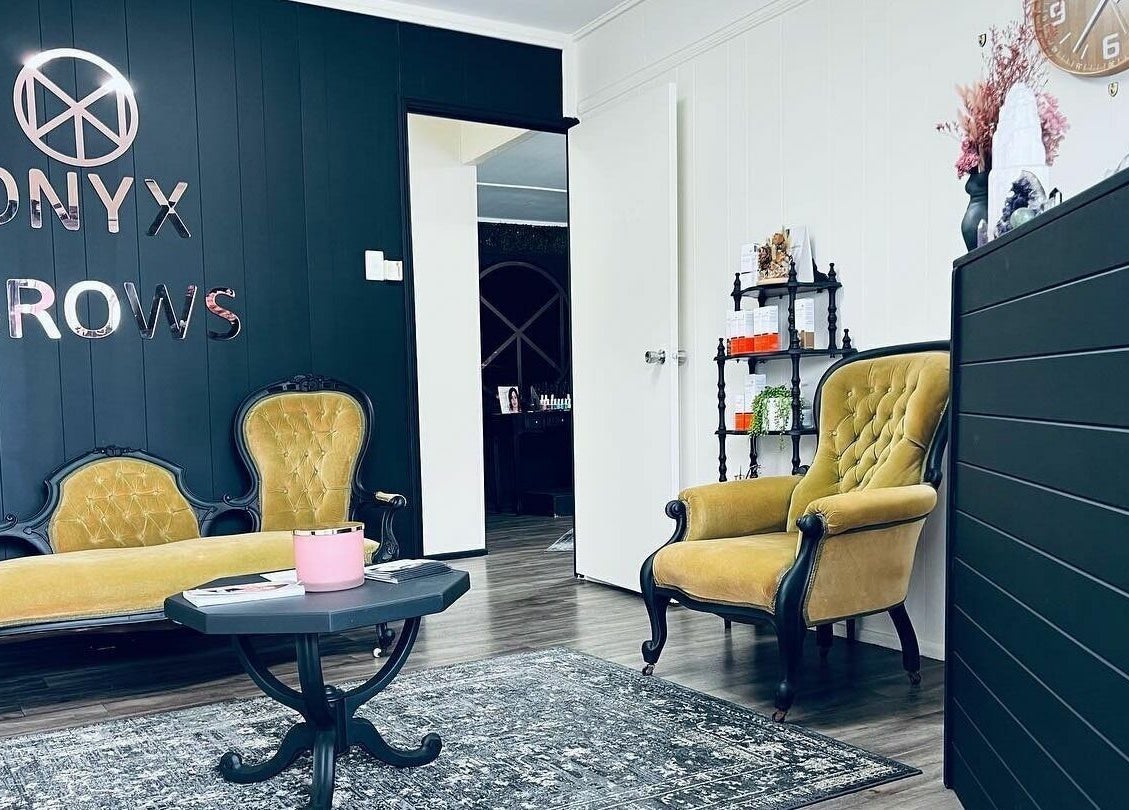 Comfortable seating area at Onyx Brows, North Mackay, Queensland, AU, showcasing elegant decor and soothing ambiance.