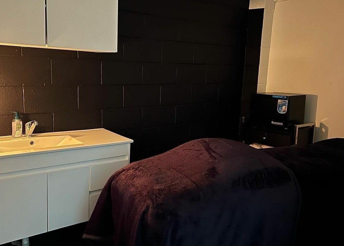 Tranquil treatment room at Onyx Brows, North Mackay, Queensland, AU with ambient lighting and comfortable bed.