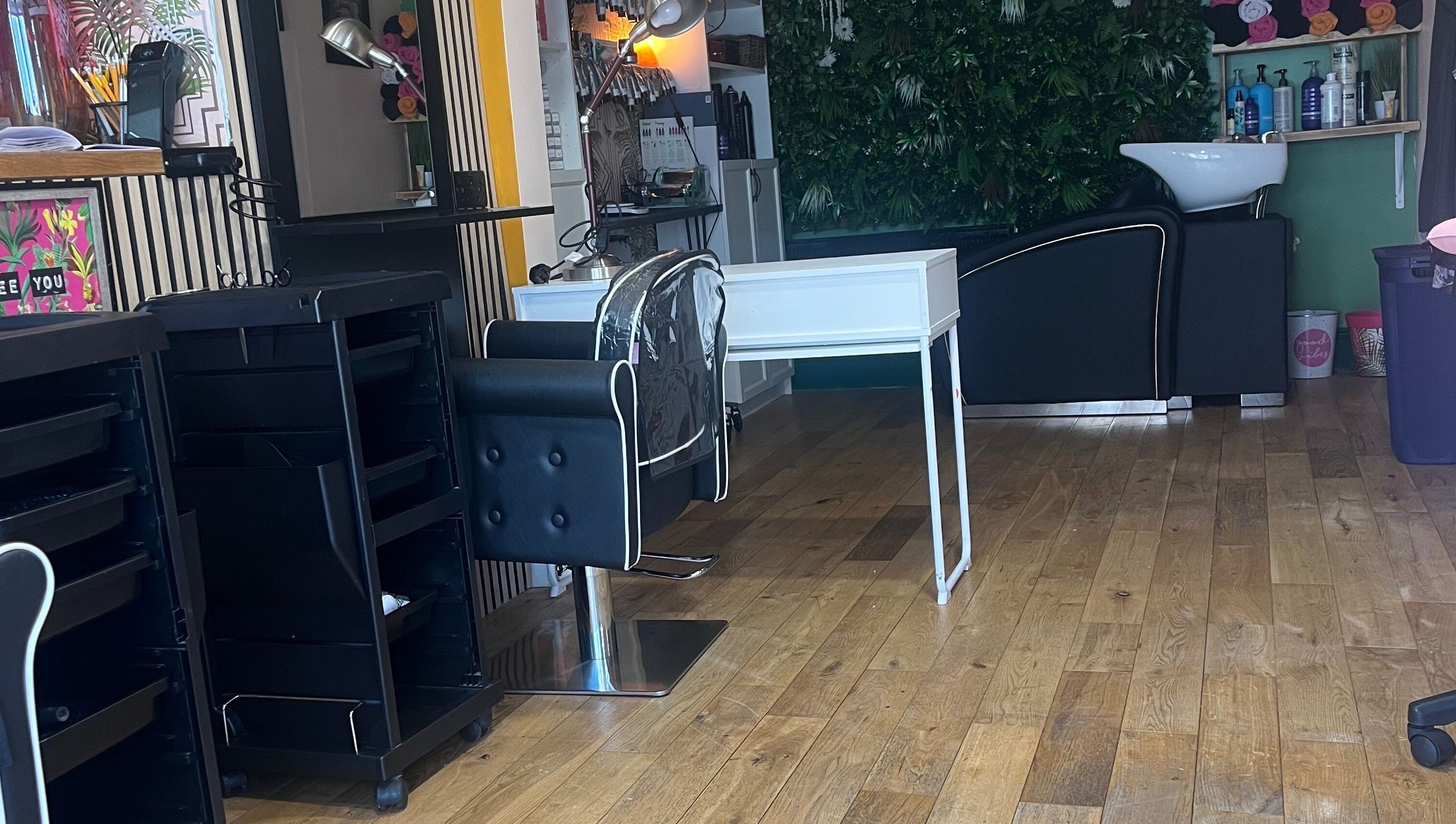 Chic interior of Knock Knock Who’s Hair in Porthcawl, Wales, GB featuring styling chair and washing station.