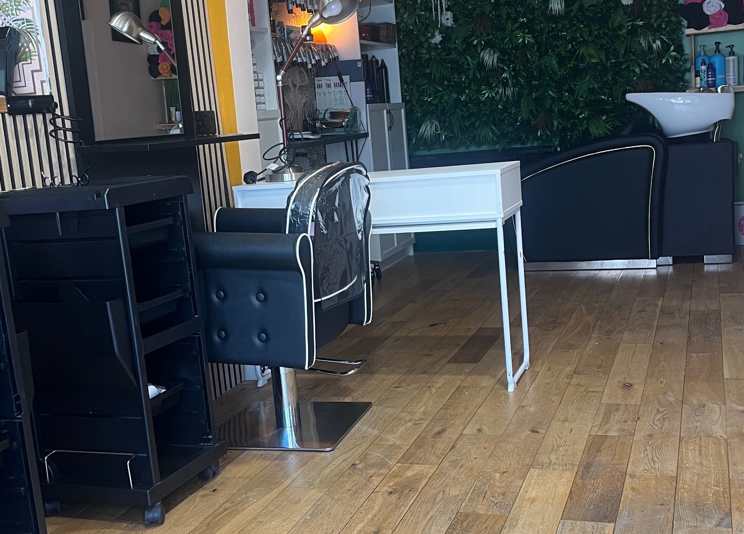 Chic interior of Knock Knock Who’s Hair in Porthcawl, Wales, GB featuring styling chair and washing station.