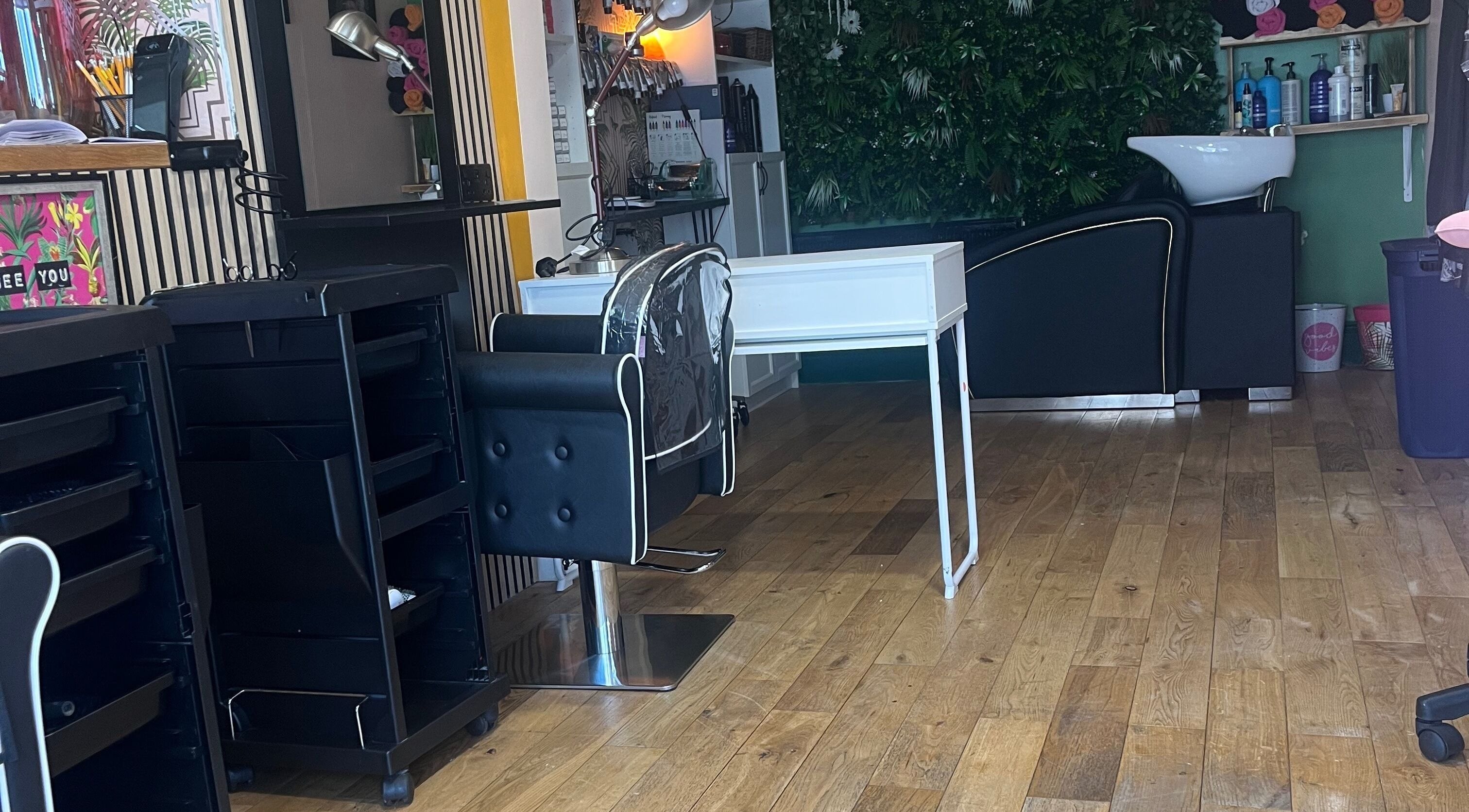 Chic interior of Knock Knock Who’s Hair in Porthcawl, Wales, GB featuring styling chair and washing station.