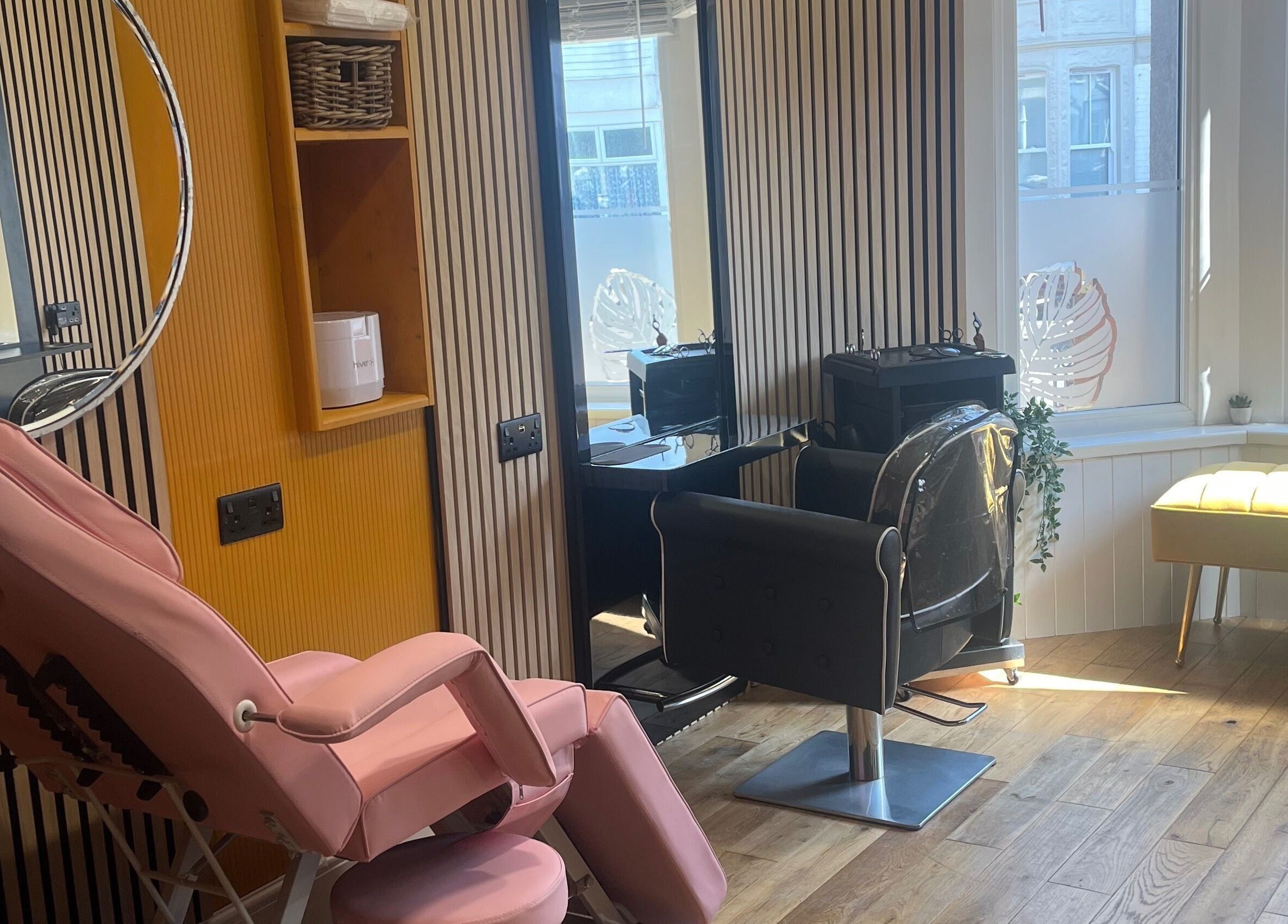 Stylish salon setup at Knock Knock Who’s Hair? in Porthcawl, Wales, GB featuring modern decor and seating.
