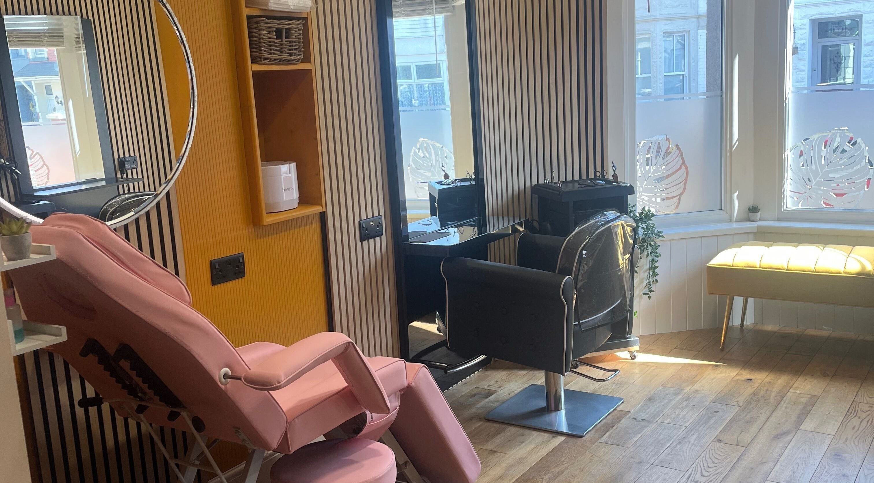 Stylish salon setup at Knock Knock Who’s Hair? in Porthcawl, Wales, GB featuring modern decor and seating.