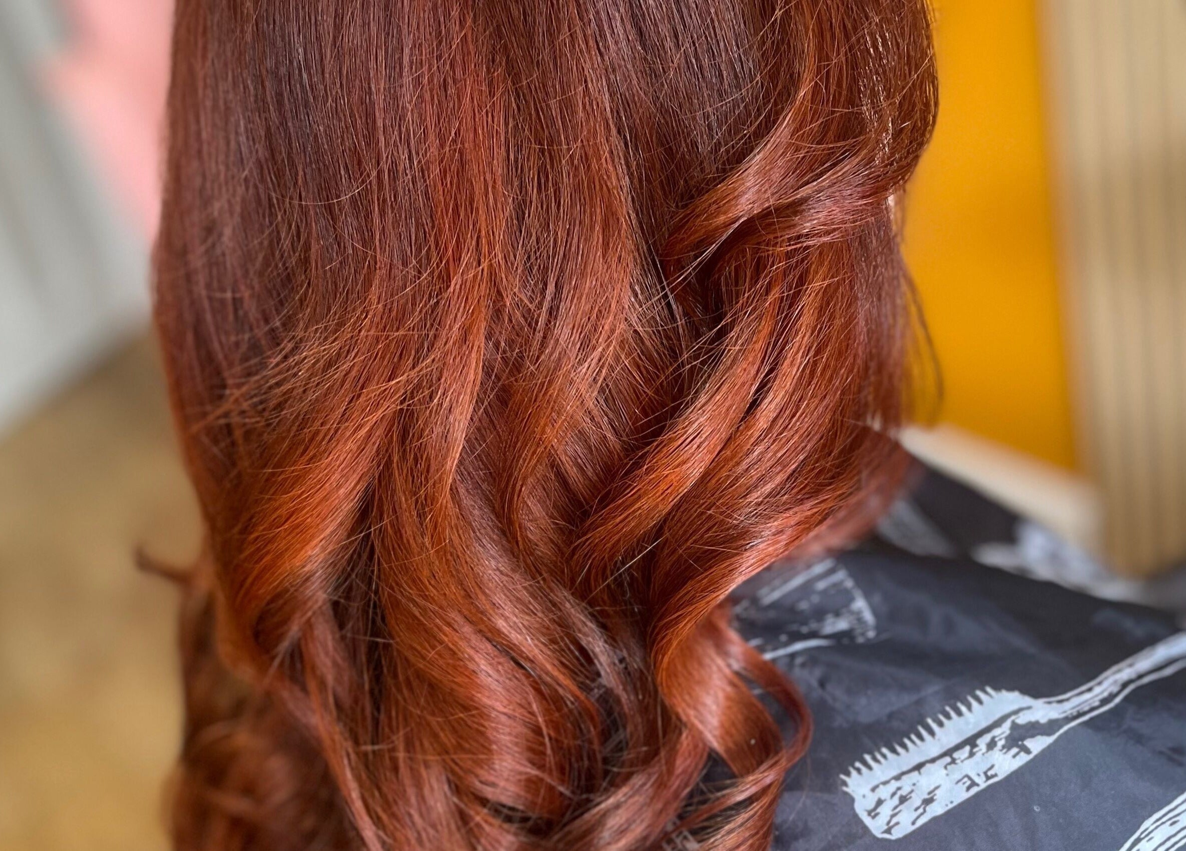 Rich auburn curls styled at Knock Knock Who’s Hair? in Porthcawl, Wales, GB, showcasing vibrant color and texture.