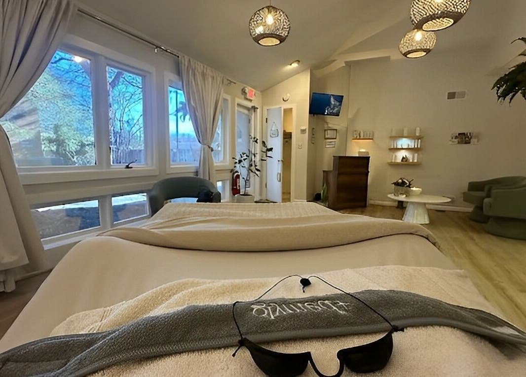 Relaxing spa room at The Skin Tune in Ramsey, New Jersey, US, featuring cozy seating and soft lighting.