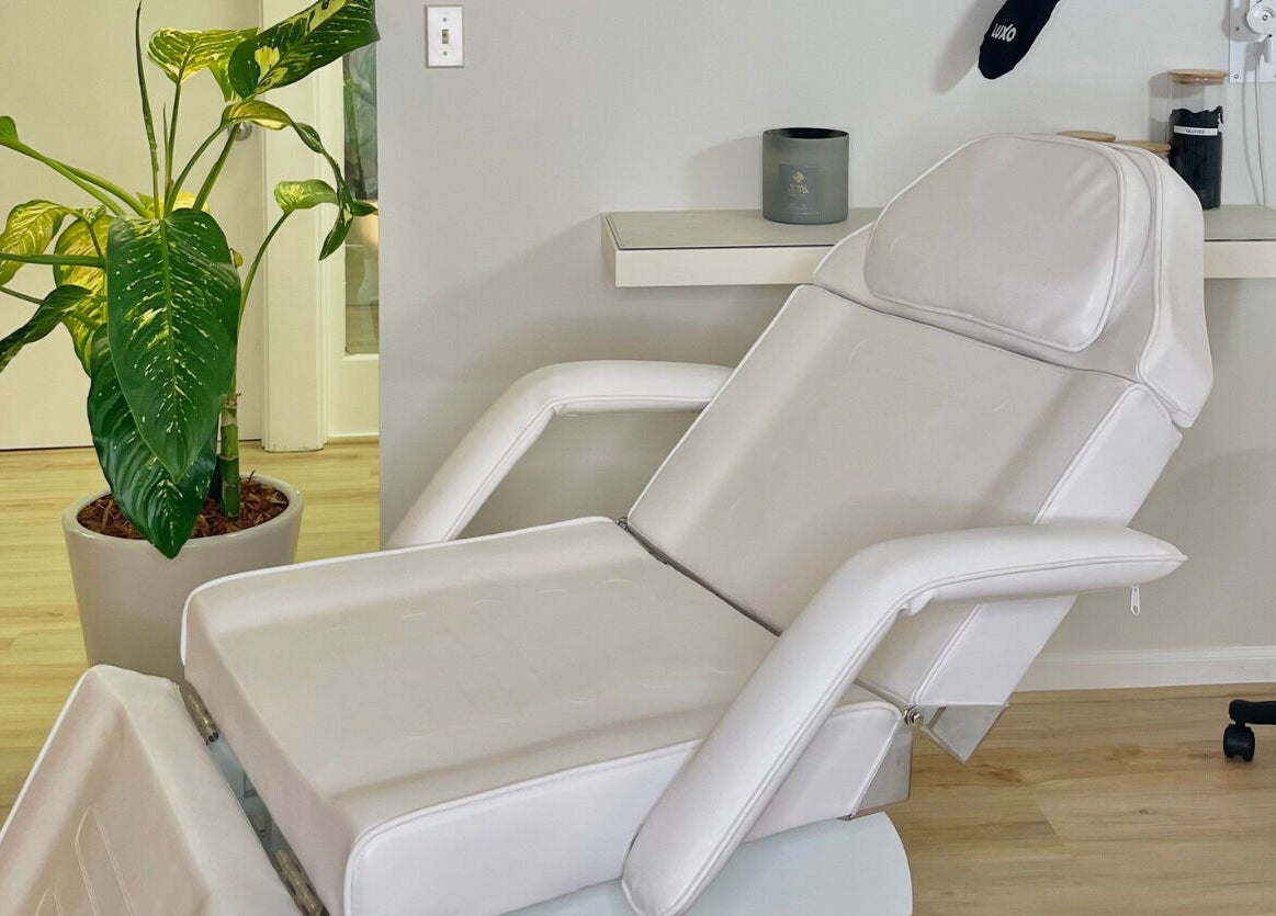 Luxurious treatment chair at The Skin Tune, Ramsey, New Jersey, US offering a tranquil ambiance with green plants.