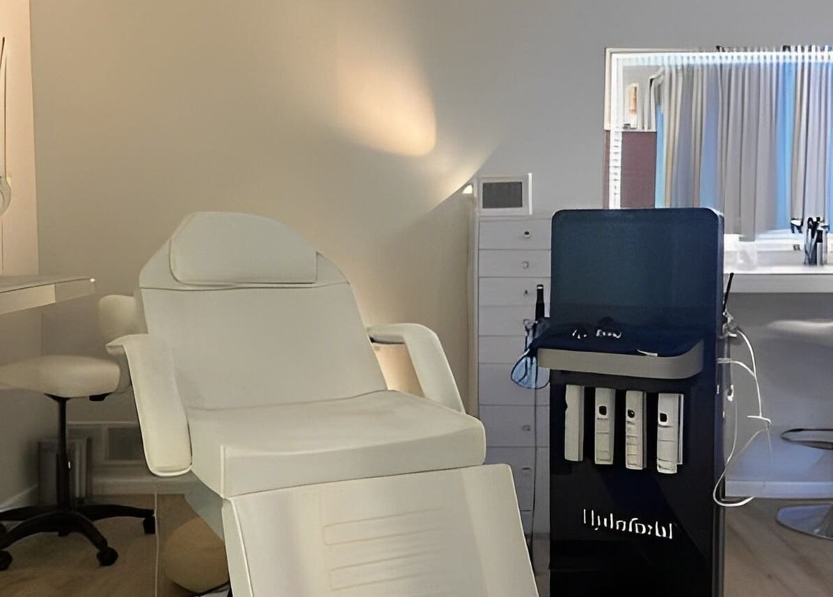 Modern treatment room at The Skin Tune in Ramsey, New Jersey, US, featuring a sleek white chair and equipment.