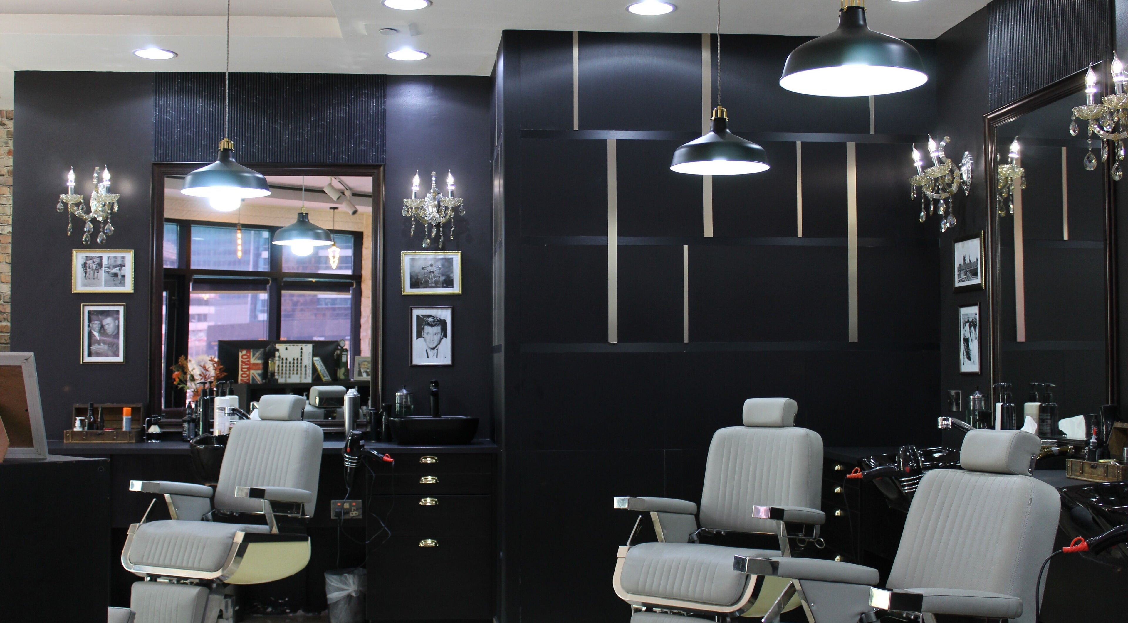 Interior of James Pro Barbers in Dubai, Dubai, AE, showcasing modern black and grey decor with stylish furnishings.