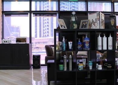 Interior of James Pro Barbers in Dubai, Dubai, AE showcasing modern grooming products and city view.